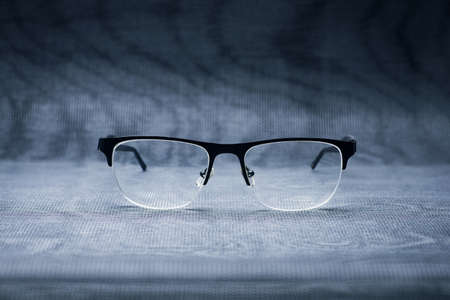 black stylish eye glasses for view on a metallic backgroundの写真素材