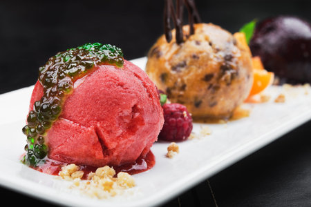 tasty ice cream with fruits on a white table, delicious dessert at restaurantの写真素材