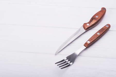 knife and fork on wooden table.cutlery on backgroundの写真素材