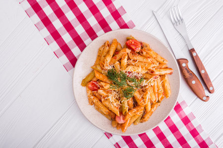 delicious penne pasta on wood white table. tasty italian dinner.top viewの写真素材