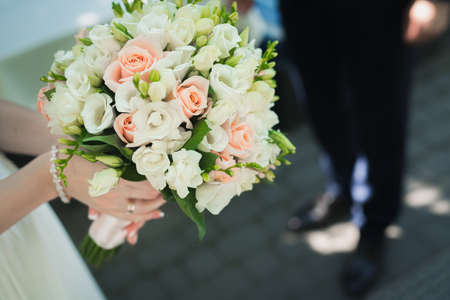 bride holding wedding flower bouquet outdoors.  romantic backgroundの写真素材