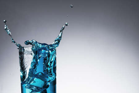 Water splash with bubble in glasses on backgroundの写真素材