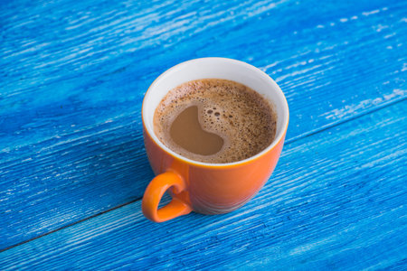 orange cup of coffee. tasty breakfast backgroundの写真素材