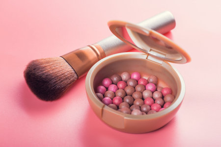 Powder balls and cosmetic brush on pink background. beauty makeup productの写真素材