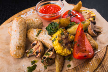 Grilled Vegetables and sausage on craft paper.nutritious food right from the grill. top viewの写真素材