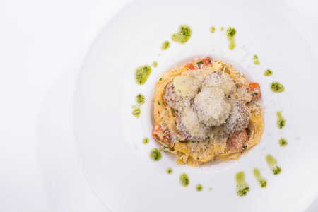 italian tagliatelle pasta with meat balls in a white tableの写真素材