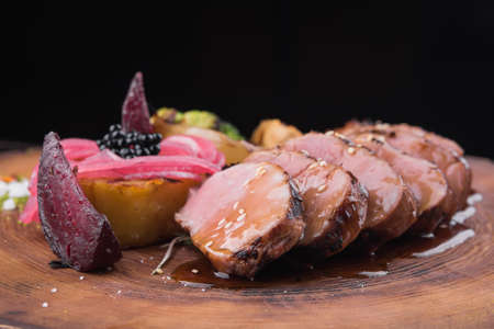 juicy veal steak with grilled vegetables in a restaurantの写真素材