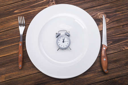 top view of plate with clock. diet concept backgroundの写真素材