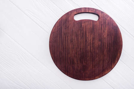 vintage used cut board on a white wood tableの写真素材