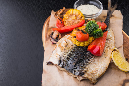 Grilled Vegetables and fish mackerel on craft paper.nutritious food right from the grillの写真素材