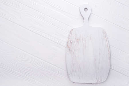 vintage used cut board on a white wood tableの写真素材