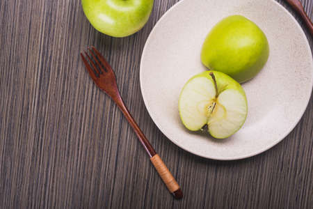 green apple fruit on a plate. top view. vegetarian breakfastの写真素材