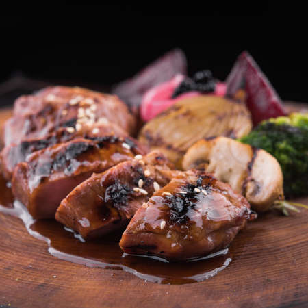 juicy veal steak with grilled vegetables in a restaurantの写真素材