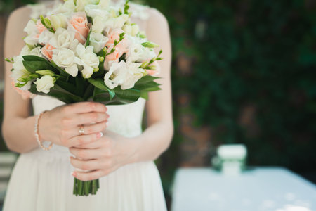 bride holding wedding flower bouquet outdoors.  romantic backgroundの写真素材