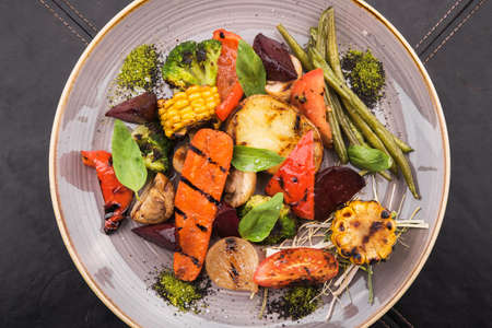 grilled vegetable tomato, corn, onion, pepper, garlic and eggplant. tasty barbecue food plateの写真素材