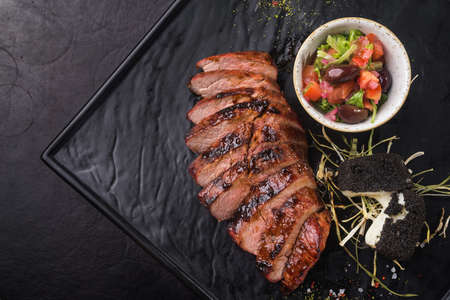 beef steak with tomato salad serving in a restaurantの写真素材