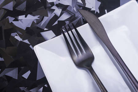 Empty white plate with knife and fork. view from topの写真素材