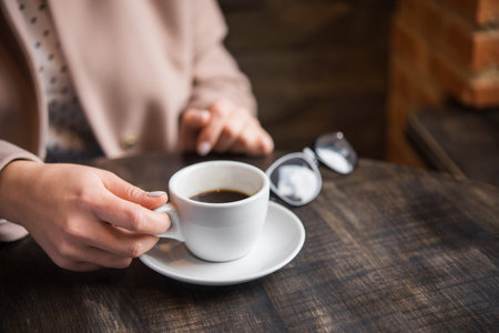 woman with white coffee cup on a table. lifestyle of business  lady. breakfast in the restaurant