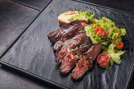 beef steak with tomato salad serving in a restaurantの写真素材