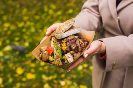 street grill bbq set of meat and vegetables, mushrooms and zucchini in a paper plate. Delicious snack at the street food festivalの写真素材