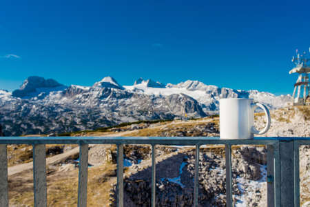 Hot cup of coffee overlooking the mountain, delicious break on top of alpsの写真素材