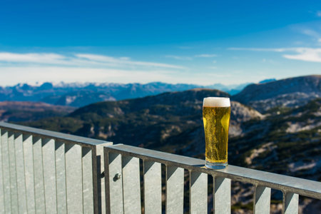 A glass of fresh beer on top of the mountains Alpsの写真素材