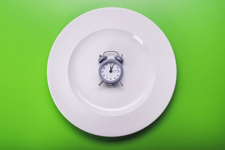 top view of plate with clock. diet concept backgroundの写真素材