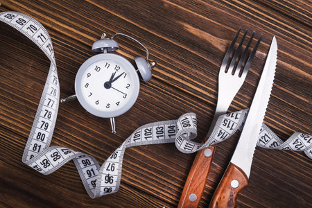 clock with measuring tape. diet concept. top view