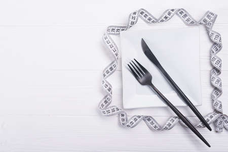 fork and knife with white measuring tape. diet food backgroundの写真素材