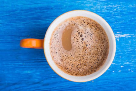 orange cup of coffee. tasty breakfast backgroundの写真素材