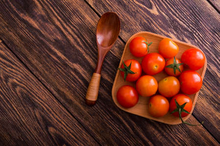 fresh red tomato on a plate. wood tableの写真素材