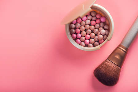 Powder balls and cosmetic brush on pink background. beauty makeup productの写真素材