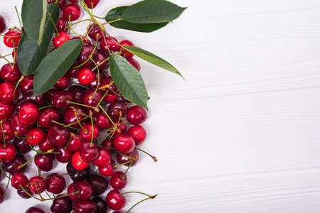 fresh red cherry on white wooden backgroundの写真素材