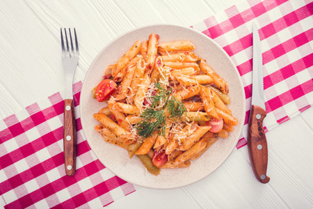 delicious penne pasta on wood white table. tasty italian dinner.top viewの写真素材