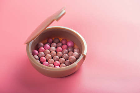 Powder balls and cosmetic brush on pink background. beauty makeup productの写真素材