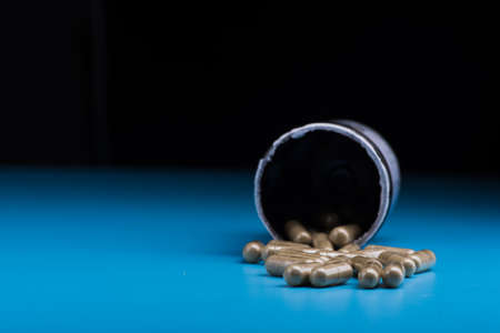 Herbal pills on a blue background. Bad supplementの写真素材