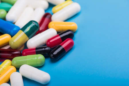 pharmaceutical pill and tablets on blue backgroundの写真素材