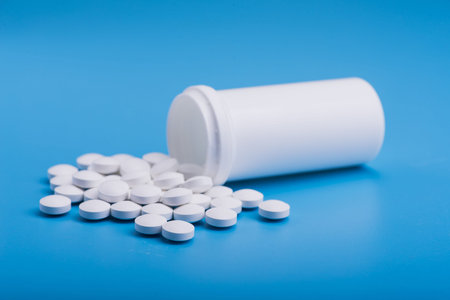 White medical pills on a blue background