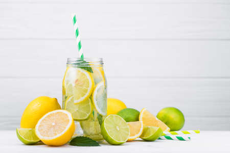 tasty lemonade drink with lemon, lime and mint on wood white tableの写真素材