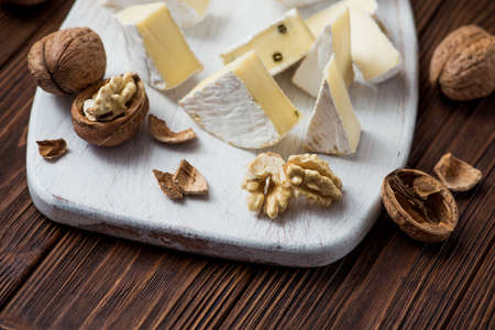 walnut with brie cheese on wooden table. milk product backgroundの写真素材