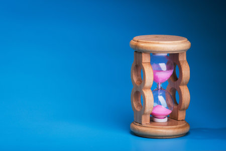 close up of hourglass on a blue background