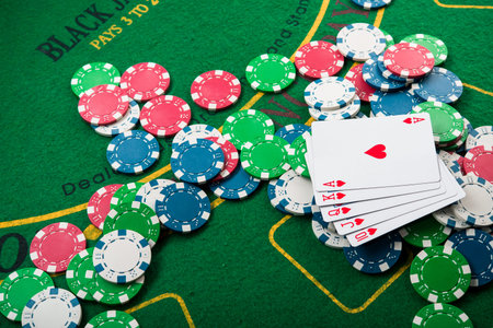 royal flash on cards and poker chips on green casino table. success in gambling