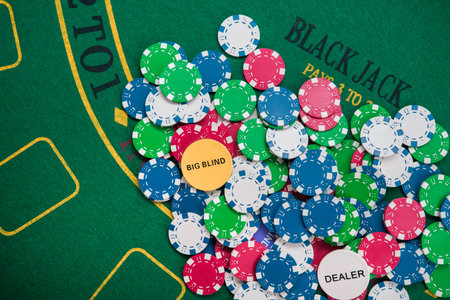 colored poker chips on green casino table. gambling entertainment. top view