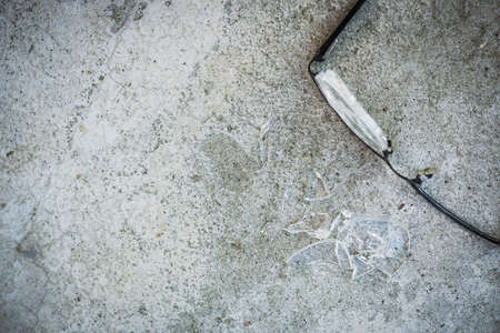 broken glasses on the asphalt. street accident concept. poor eyesightの写真素材