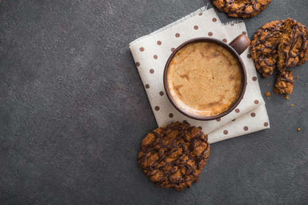 Hot coffee cup with chocolate cookies on stone table. top view with copyspaceの写真素材