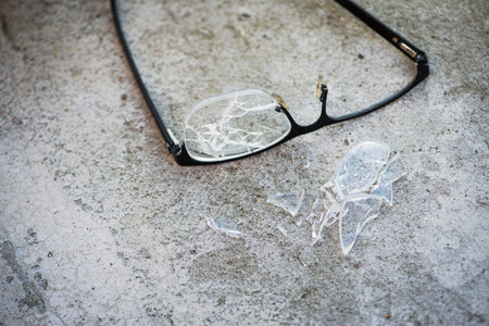 broken glasses on the asphalt. street accident concept. poor eyesightの写真素材