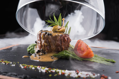 grilled beef fillet medallion with  pesto sauce and tomato の写真素材