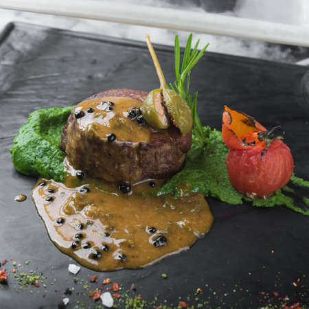 grilled beef fillet medallion with  pesto sauce and tomato の写真素材