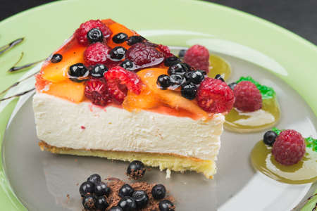 sweet dessert cake with raspberry and currant fruit on a plateの写真素材