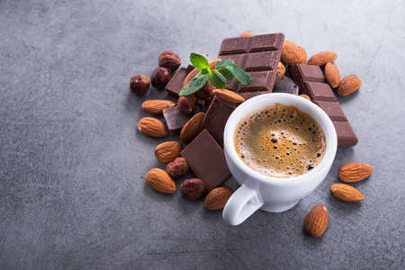 Aroma coffee cup with chocolate bars on a stone table, top viewの写真素材